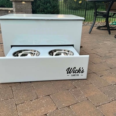 The Retriever — white Wick's Lake Co full-size dog station with a pull-out drawer holding two stainless bowls