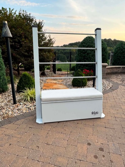 The Drydock — white Wick's Lake Co towel and lake-gear station with stainless rails