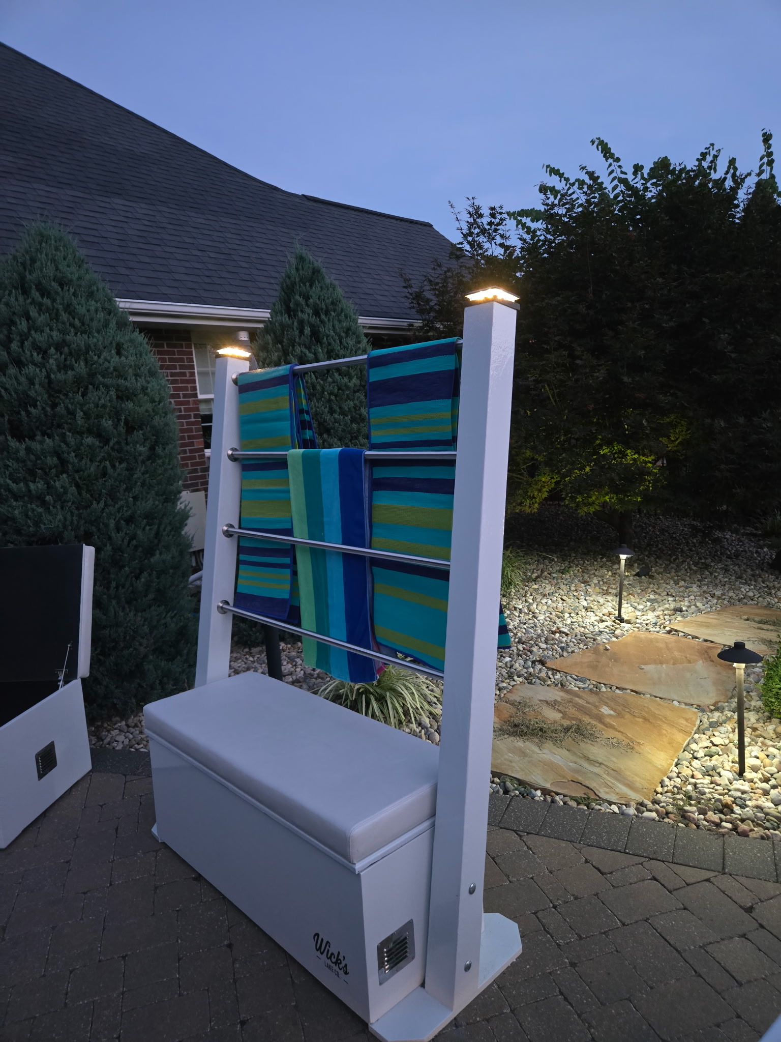 The Drydock at dusk with towels on the rails and lighted posts
